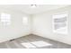 Bright bedroom with three windows that bring in natural light and grey carpet at 13382 E 110Th Way, Commerce City, CO 80022