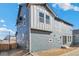 Exterior view of the two-story home featuring modern, mixed material siding and a well-manicured lawn at 13382 E 110Th Way, Commerce City, CO 80022