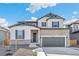 Beautiful two-story home with stone accents, a two-car garage, and manicured landscaping at 13382 E 110Th Way, Commerce City, CO 80022