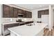 Modern kitchen features dark cabinets, stainless steel appliances, quartz countertops, and tiled backsplash at 13382 E 110Th Way, Commerce City, CO 80022