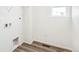 Bright laundry room with washer and dryer hookups, and wood-look tile flooring at 13382 E 110Th Way, Commerce City, CO 80022