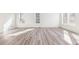 Spacious living area featuring wood floors, large windows, and neutral tones for versatile decor options at 13382 E 110Th Way, Commerce City, CO 80022