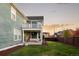 Home's backyard with deck and grassy area at 6003 Chester Way, Denver, CO 80238