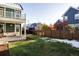 Backyard with grassy lawn and privacy fence at 6003 Chester Way, Denver, CO 80238