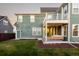 Home's backyard with large deck and grassy area at 6003 Chester Way, Denver, CO 80238