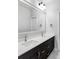 Double vanity bathroom with dark brown cabinets and white countertop at 6003 Chester Way, Denver, CO 80238