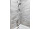 Bathroom with shower and bathtub, featuring gray tile and modern fixtures at 6003 Chester Way, Denver, CO 80238