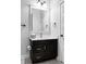 Bathroom with dark vanity, mirror, and white countertop at 6003 Chester Way, Denver, CO 80238
