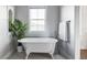 Spa-like bathroom features a clawfoot tub and a large window at 6003 Chester Way, Denver, CO 80238