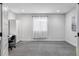 Spacious bedroom with gray carpeting, window, and built-in closet at 6003 Chester Way, Denver, CO 80238