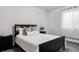 Main bedroom with a queen-size bed, nightstand, and window at 6003 Chester Way, Denver, CO 80238