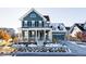 Two-story craftsman style home with front porch at 6003 Chester Way, Denver, CO 80238
