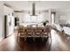 Modern kitchen featuring white cabinetry, a large island, and stainless steel appliances at 6003 Chester Way, Denver, CO 80238