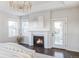 Main bedroom with fireplace, access to balcony, and hardwood floors at 6003 Chester Way, Denver, CO 80238