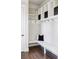 White mudroom with bench, cubbies, and hooks at 6003 Chester Way, Denver, CO 80238