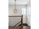 Elegant staircase with a wrought iron railing and hardwood flooring at 6003 Chester Way, Denver, CO 80238