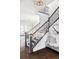 Elegant staircase with dark wood railings and a light and airy feel at 6003 Chester Way, Denver, CO 80238