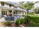 Beautiful back patio with outdoor seating, manicured lawn, and elegant home exterior at 1512 Cottonwood Ln, Greenwood Village, CO 80121