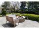 Backyard patio area with a fire pit, lounge chairs, storage shed and trees at 1512 Cottonwood Ln, Greenwood Village, CO 80121