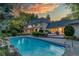 Luxurious backyard with swimming pool, stone patio, and well-maintained landscaping, ideal for outdoor enjoyment at 1512 Cottonwood Ln, Greenwood Village, CO 80121
