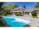 Sprawling backyard with a large pool, stone patio, mature trees and lush landscaping at 1512 Cottonwood Ln, Greenwood Village, CO 80121