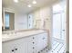 Bright bathroom features double sinks, a large mirror, and a walk-in shower with a glass door at 1512 Cottonwood Ln, Greenwood Village, CO 80121