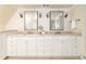 Bathroom featuring a double vanity with stone countertops, ample storage, and modern lighting at 1512 Cottonwood Ln, Greenwood Village, CO 80121