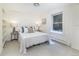 Bright bedroom with a white comforter, neutral paint, large window and side tables with lamps at 1512 Cottonwood Ln, Greenwood Village, CO 80121