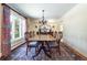 Formal dining room featuring a large window, chandelier, and beautiful hardwood floors at 1512 Cottonwood Ln, Greenwood Village, CO 80121