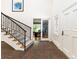Inviting foyer with stairway, decorative glass door, and brick flooring at 1512 Cottonwood Ln, Greenwood Village, CO 80121