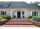 Charming home entrance with brick steps, stone retaining wall, and beautiful landscaping at 1512 Cottonwood Ln, Greenwood Village, CO 80121