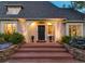 Elegant home entrance featuring a brick walkway, well-manicured shrubs, and a classic black front door at 1512 Cottonwood Ln, Greenwood Village, CO 80121
