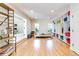 Home gym featuring exercise equipment, storage shelves, and hardwood floors, ideal for fitness and well-being at 1512 Cottonwood Ln, Greenwood Village, CO 80121