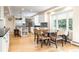 Contemporary kitchen with stainless steel appliances, white cabinetry, and a breakfast nook with backyard views at 1512 Cottonwood Ln, Greenwood Village, CO 80121