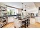 Spacious kitchen featuring a large island with bar seating, stainless steel appliances, and ample counter space at 1512 Cottonwood Ln, Greenwood Village, CO 80121