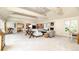 Open concept living room with coffered ceilings, a fireplace, and large windows for natural light at 1512 Cottonwood Ln, Greenwood Village, CO 80121