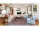 Cozy living room with a fireplace, hardwood floors, and large windows with elegant curtains at 1512 Cottonwood Ln, Greenwood Village, CO 80121