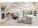Expansive living room with a fireplace, coffered ceiling, and multiple seating areas with backyard views at 1512 Cottonwood Ln, Greenwood Village, CO 80121