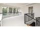 Open loft area with decorative iron railings and large windows providing views of the outside at 1512 Cottonwood Ln, Greenwood Village, CO 80121