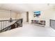 Open loft area featuring a decorative chandelier, iron railings, a bookshelf, and neutral carpet at 1512 Cottonwood Ln, Greenwood Village, CO 80121