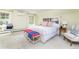 Bright bedroom with a bed, built-in headboard shelving, natural light, and neutral carpet at 1512 Cottonwood Ln, Greenwood Village, CO 80121