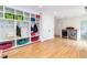Bright mudroom featuring built-in shelving with colorful baskets, a coat rack, and a modern washer and dryer at 1512 Cottonwood Ln, Greenwood Village, CO 80121