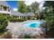 Refreshing pool with a stone surround, ladder access, and meticulously landscaped backyard at 1512 Cottonwood Ln, Greenwood Village, CO 80121