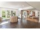 Sun-drenched sunroom with terracotta floors and large glass doors leading to the backyard at 1512 Cottonwood Ln, Greenwood Village, CO 80121