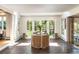 Bright sunroom featuring terracotta floors and large windows overlooking the garden at 1512 Cottonwood Ln, Greenwood Village, CO 80121