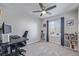 Bright bedroom featuring a ceiling fan, bookshelves, and a large window at 12133 Hannibal St, Commerce City, CO 80603