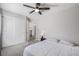 Neutral bedroom with carpet, a ceiling fan, closet, and an attached bath at 12133 Hannibal St, Commerce City, CO 80603