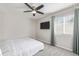 Neutral bedroom with carpet, a ceiling fan, large window and flat screen tv at 12133 Hannibal St, Commerce City, CO 80603