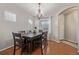 Elegant dining room with hardwood floors, chandelier, and a wooden table with six chairs at 12133 Hannibal St, Commerce City, CO 80603
