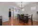 Bright dining room with hardwood floors, a large dining table with chairs, and modern decor at 12133 Hannibal St, Commerce City, CO 80603